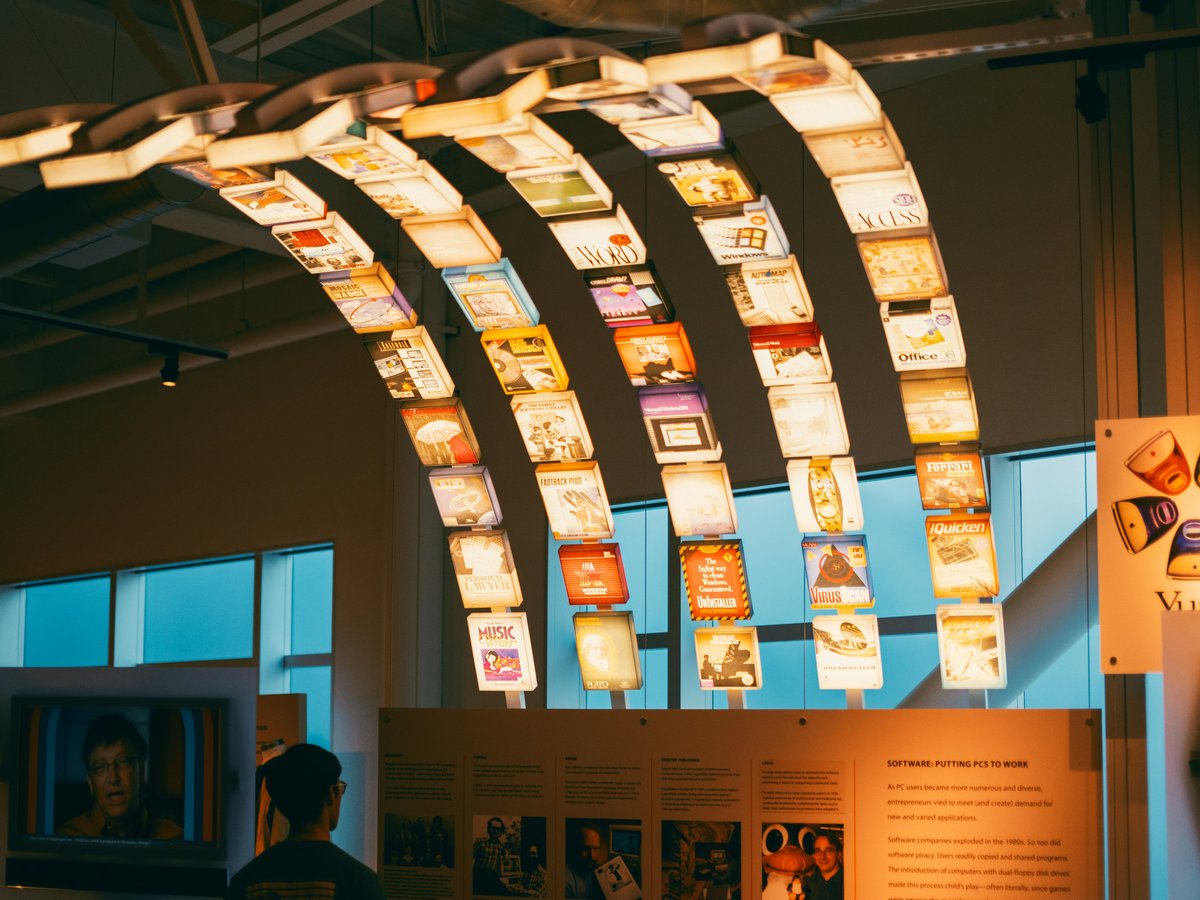 a group of people looking at a display of books