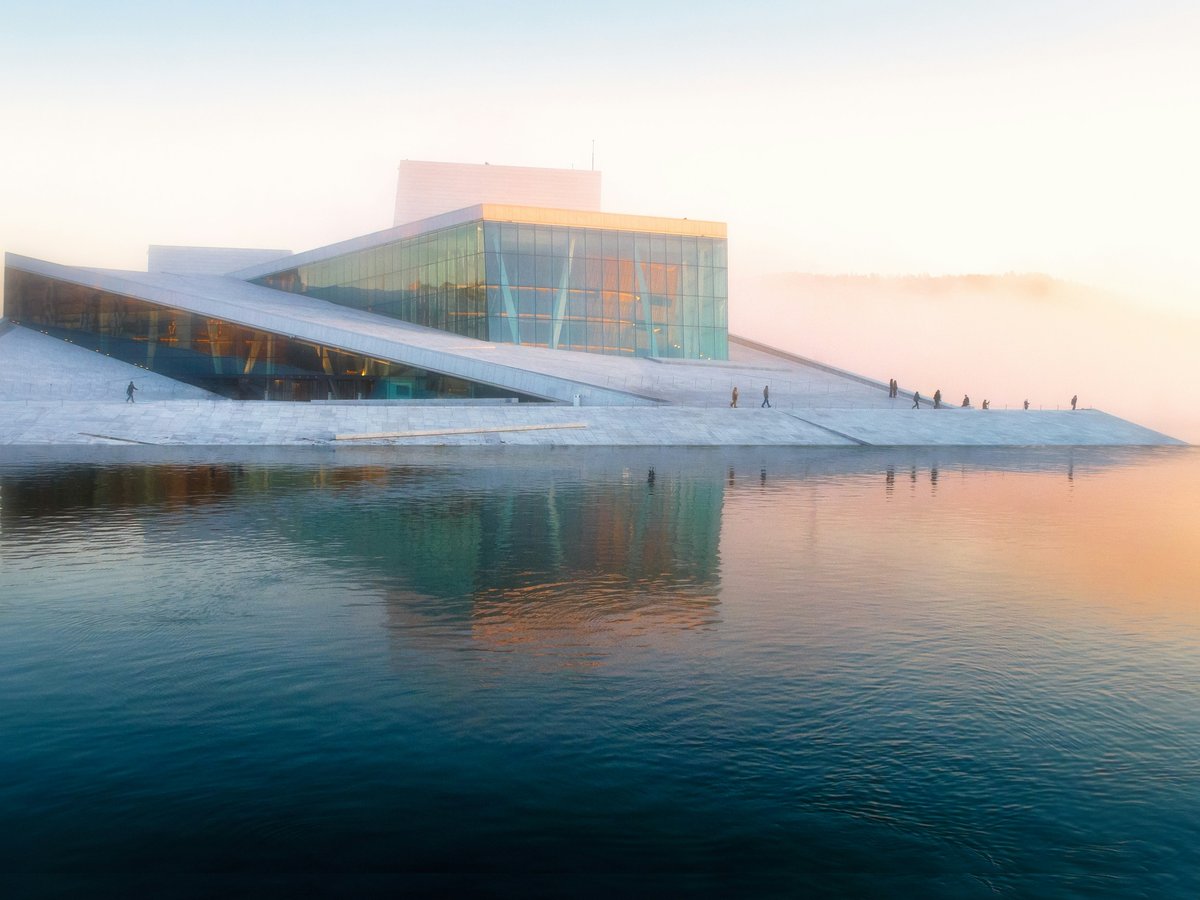 gray building near body of water under white sky