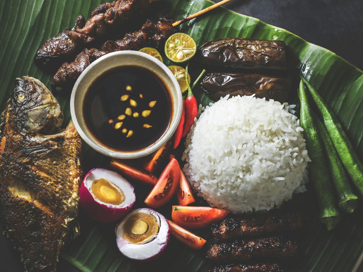 variety of fried dishes on banana leaf