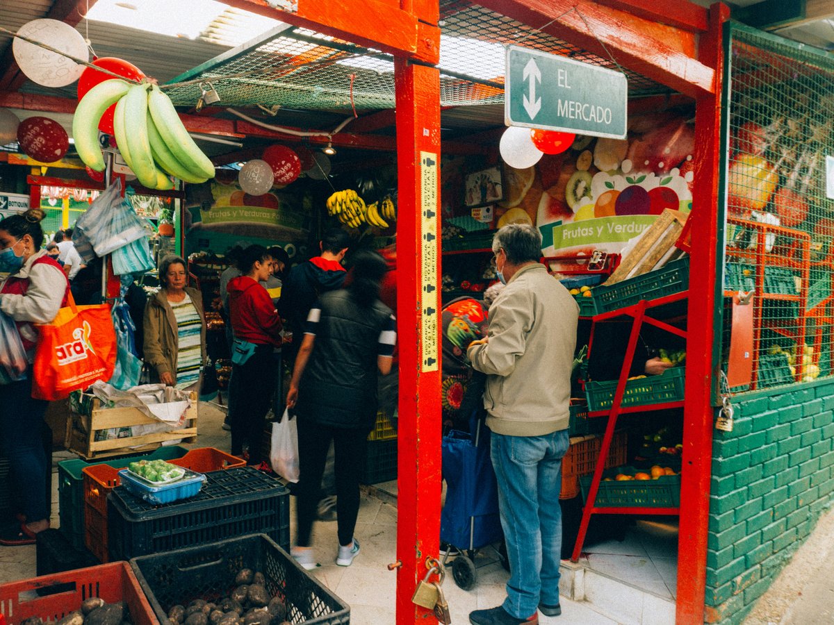 a group of people standing outside of a store