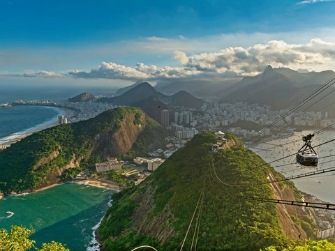 green and brown mountains near body of water during daytime