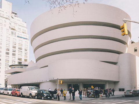 people walking on street near white concrete building during daytime