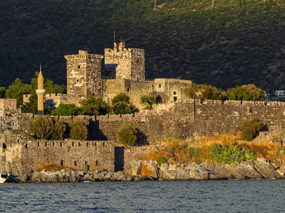 Ancient stone castle with a minaret by the sea