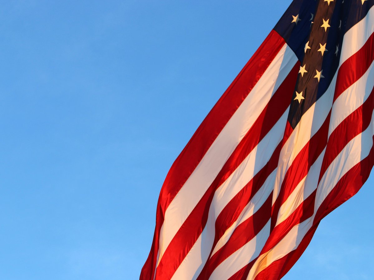 us a flag under blue sky during daytime