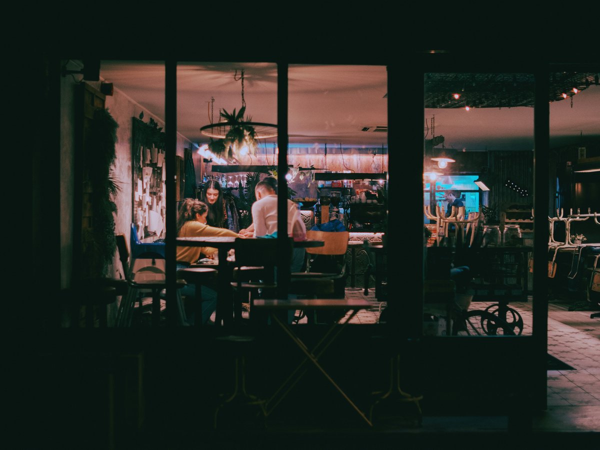 a couple of people sitting at a table in a room