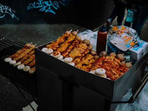 a box of food sitting on top of a grill
