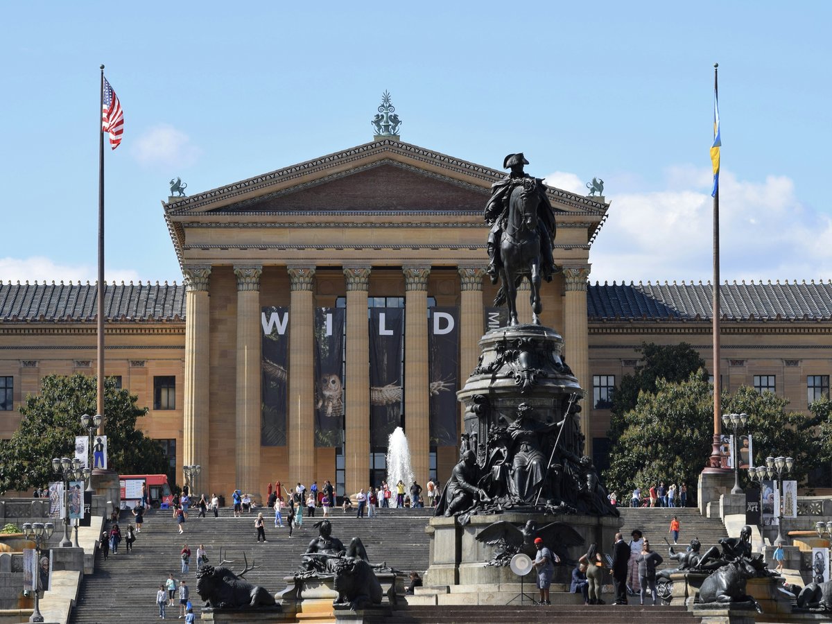 a large building with a statue in front of it