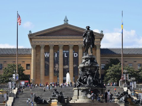 a large building with a statue in front of it