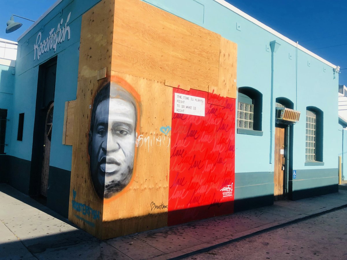mans face painted on red and white wall