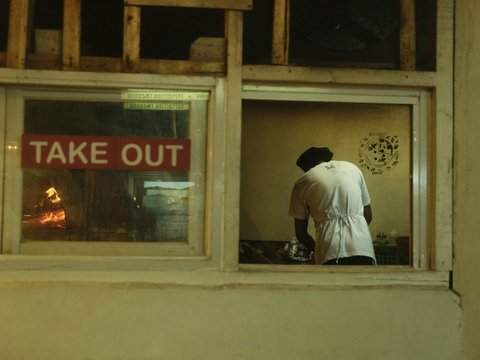 a man looking out of a window at a sign
