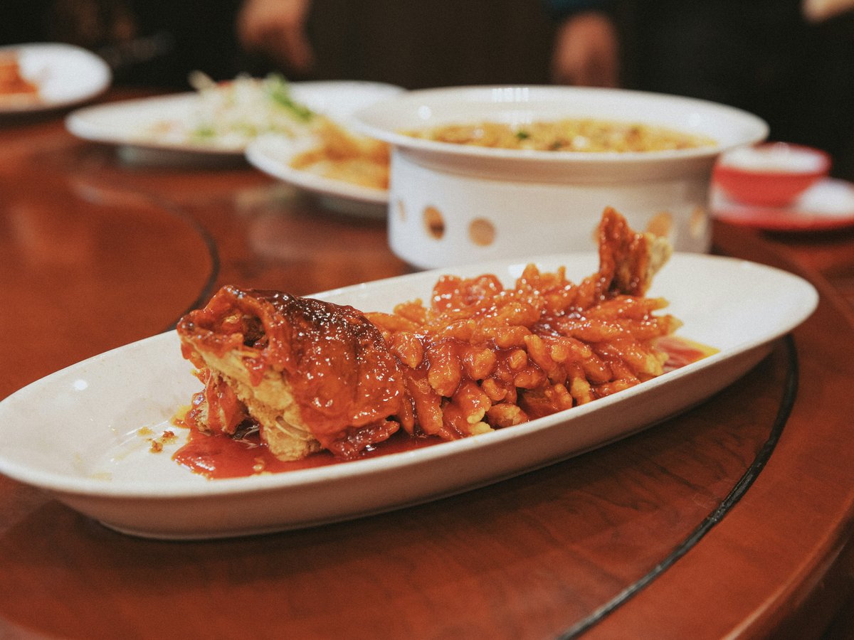 Crispy fried seafood with sweet and sour sauce on plate