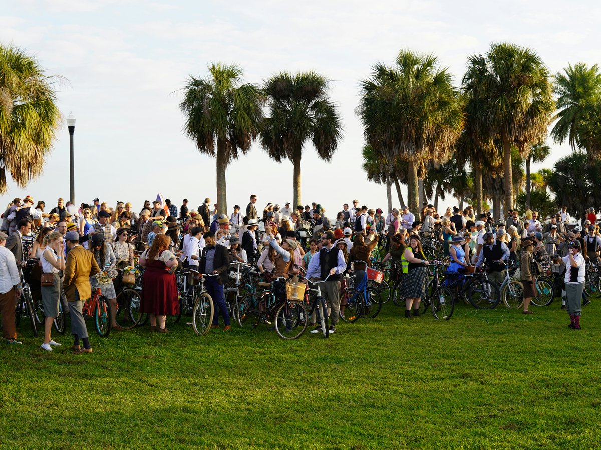 people riding bicycles on green grass field during daytime
