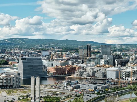 city buildings under white clouds and blue sky during daytime