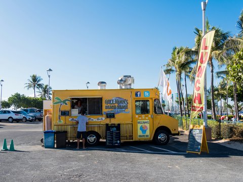 yellow multi-stop truck in parking lot