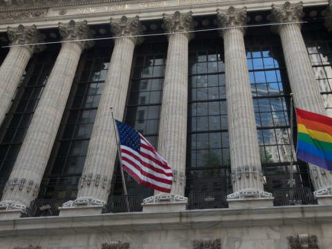 a group of flags flying in front of a building
