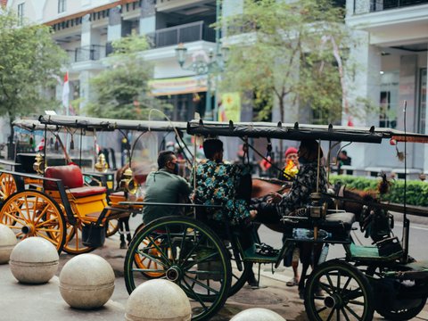 a group of people riding in a horse drawn carriage