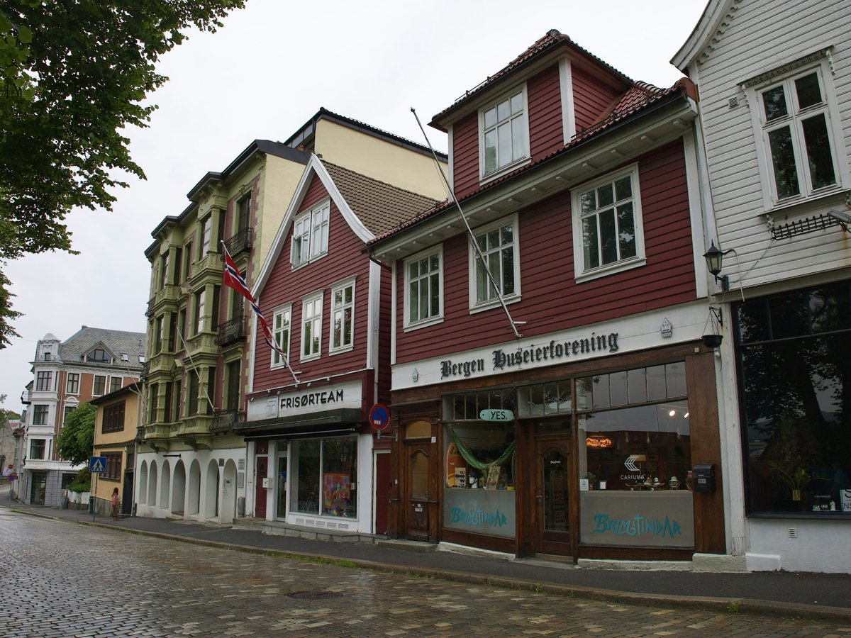 a row of buildings on a cobblestone street