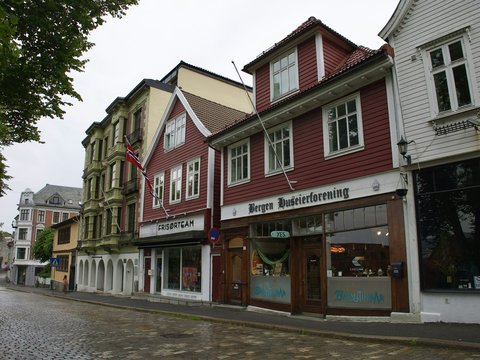 a row of buildings on a cobblestone street