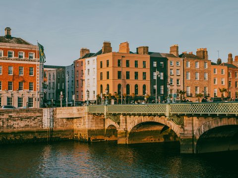 a bridge over a body of water with buildings in the background