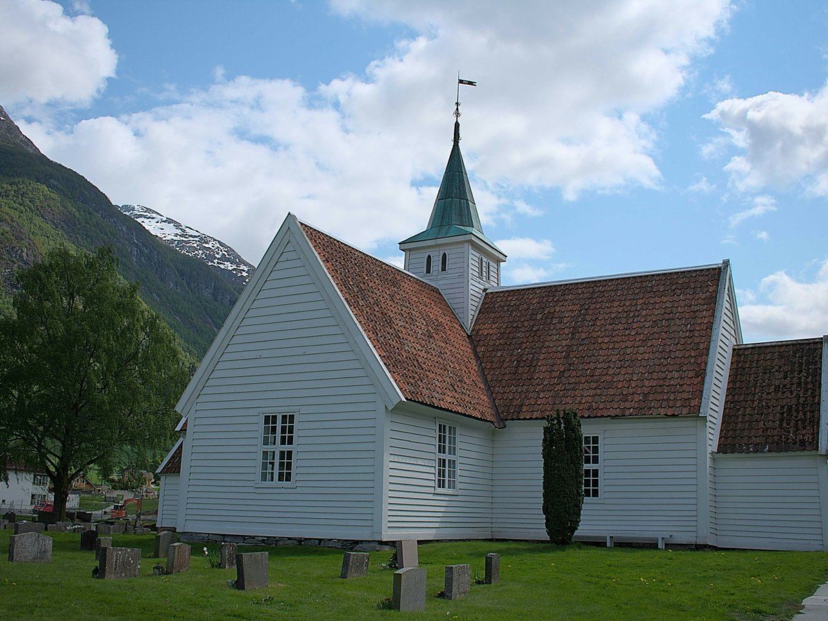 a white church with a red roof and a steeple