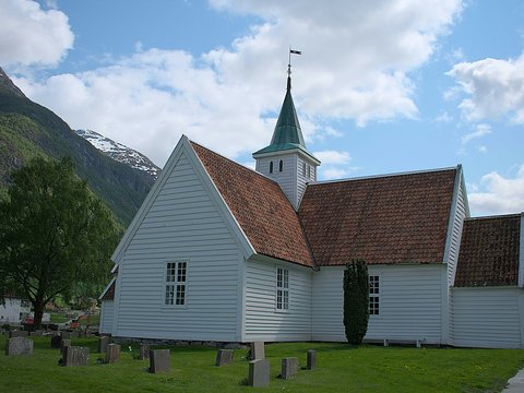 a white church with a red roof and a steeple