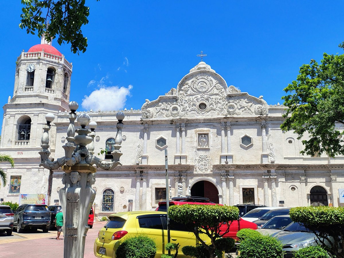 White church with red dome and bell tower