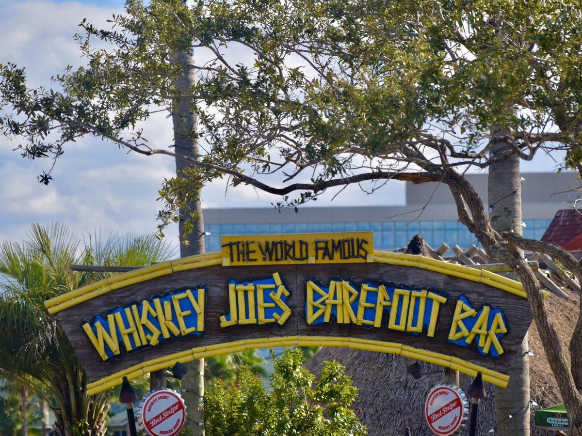 a sign with trees in the background