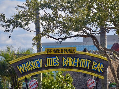 a sign with trees in the background