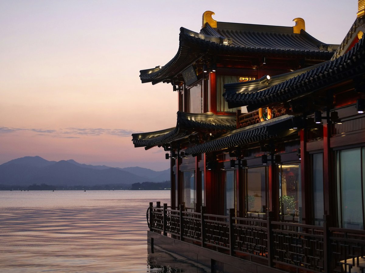 brown and red temple beside water