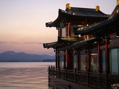 brown and red temple beside water