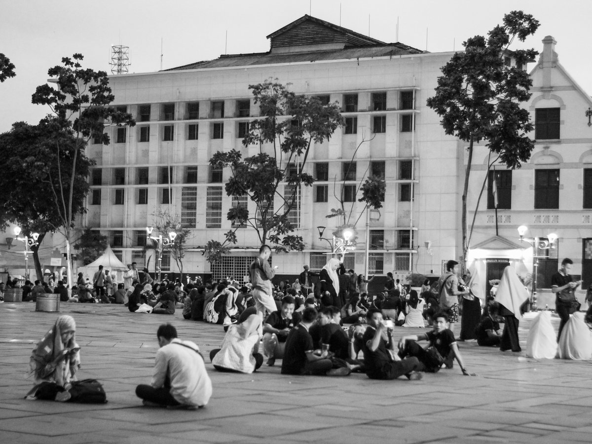 a group of people sitting outside a building