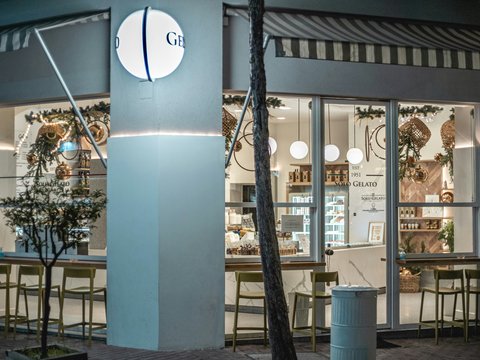 a store front with a tree in front of it