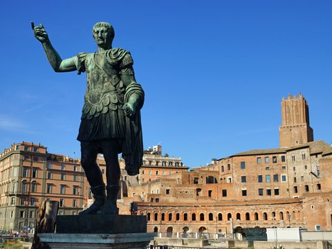 a statue of a roman soldier in front of a building