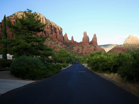 black asphalt road between brown rock formation during daytime