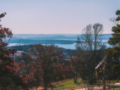 a scenic view of a lake and mountains in the distance