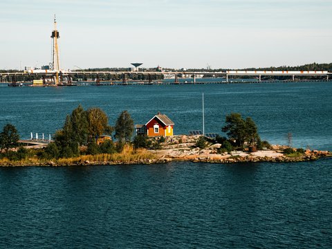 A small island in the middle of a large body of water