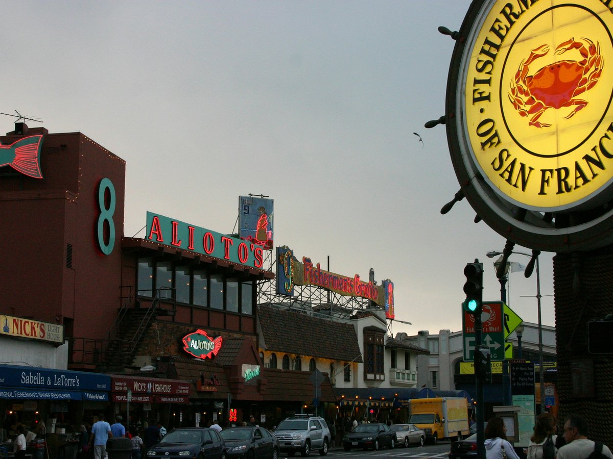a street scene with focus on a restaurant sign
