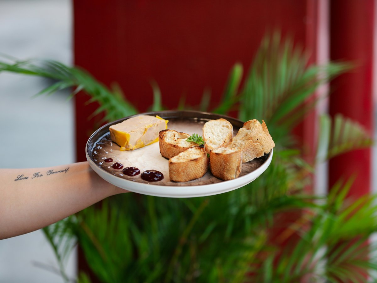 a person holding a plate with food on it