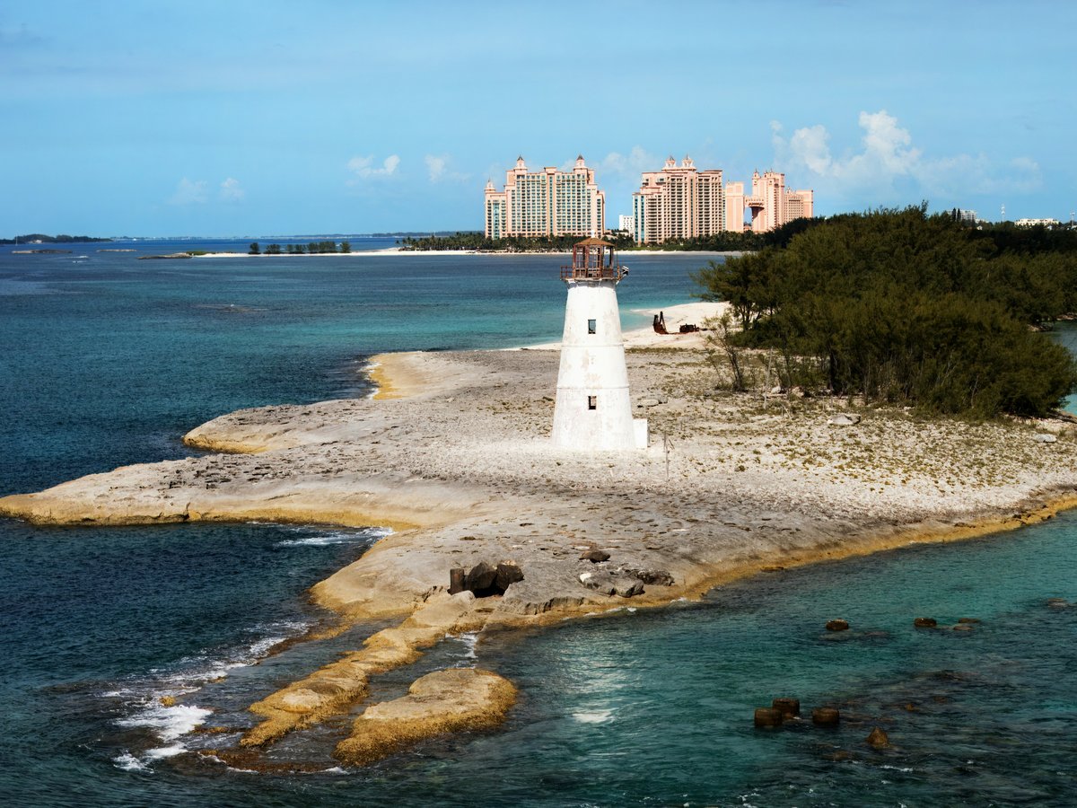 A lighthouse on an island in the middle of the ocean