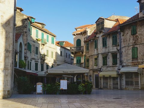 a street with a few buildings and a car parked in front of it