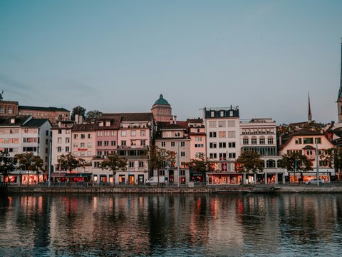 brown and white concrete building near body of water during daytime