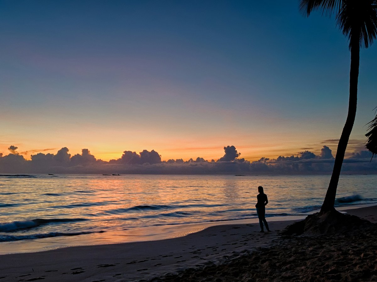 silhouette of person standing near body of water