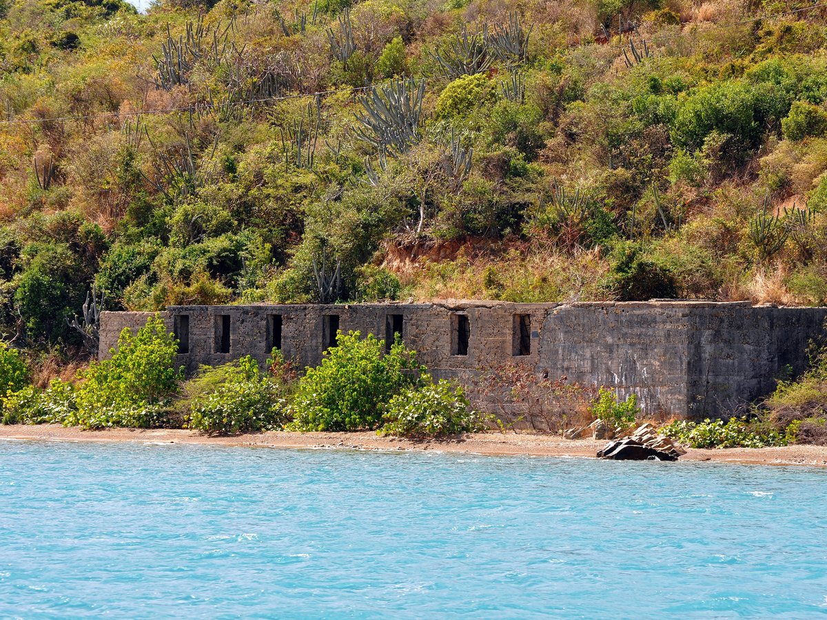 a stone building on a beach