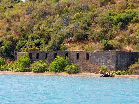 a stone building on a beach