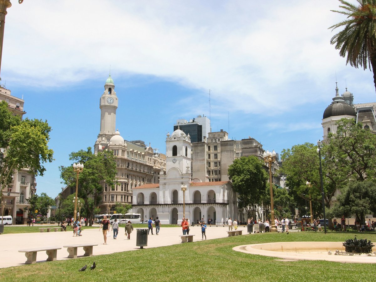 a large building with a dome and towers surrounded by trees