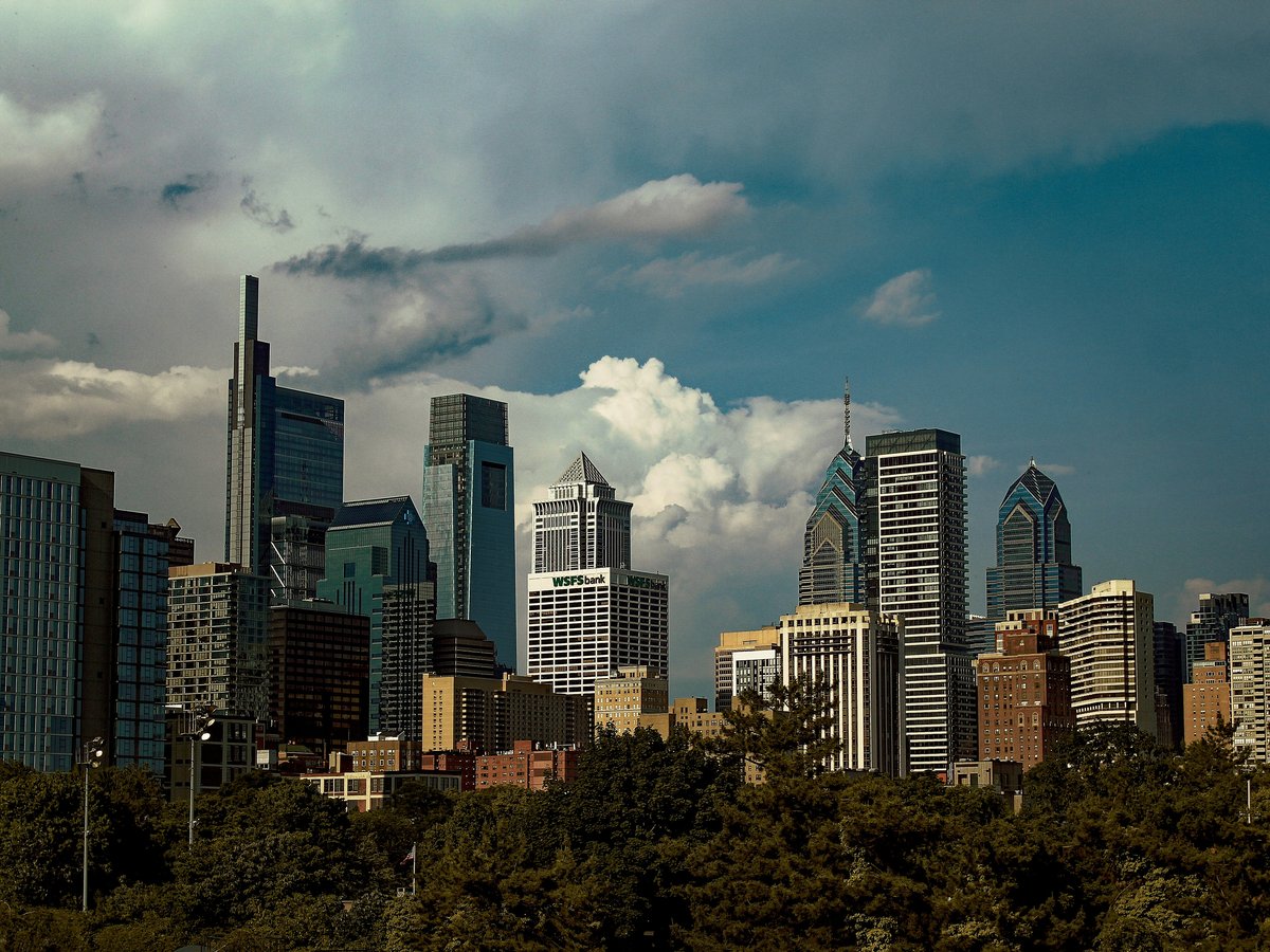 A view of a city skyline with clouds in the sky