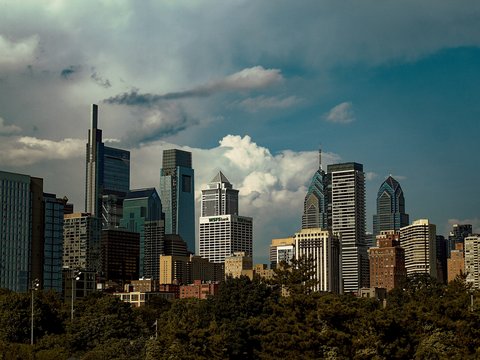 A view of a city skyline with clouds in the sky