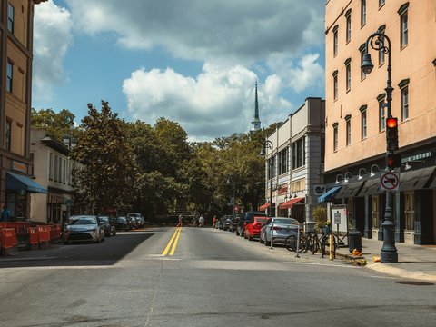 a city street with cars parked on both sides of the street