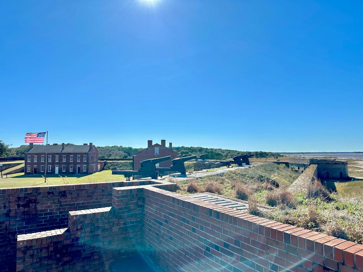 a brick wall with a flag on top of it