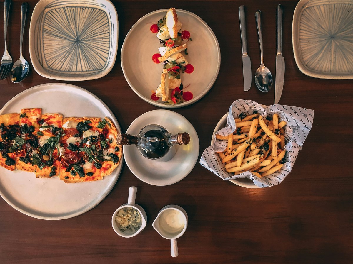 a wooden table topped with plates of food